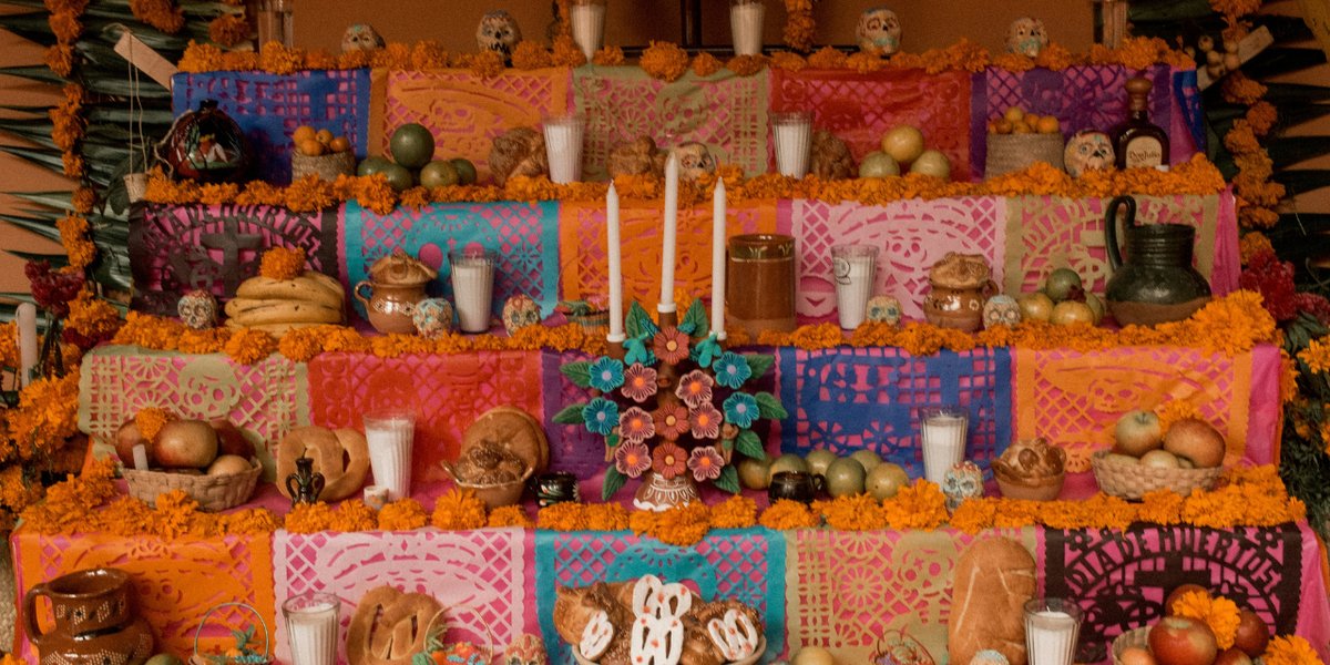 A Día de los Muertos ofrenda altar decorated with marigolds and candles