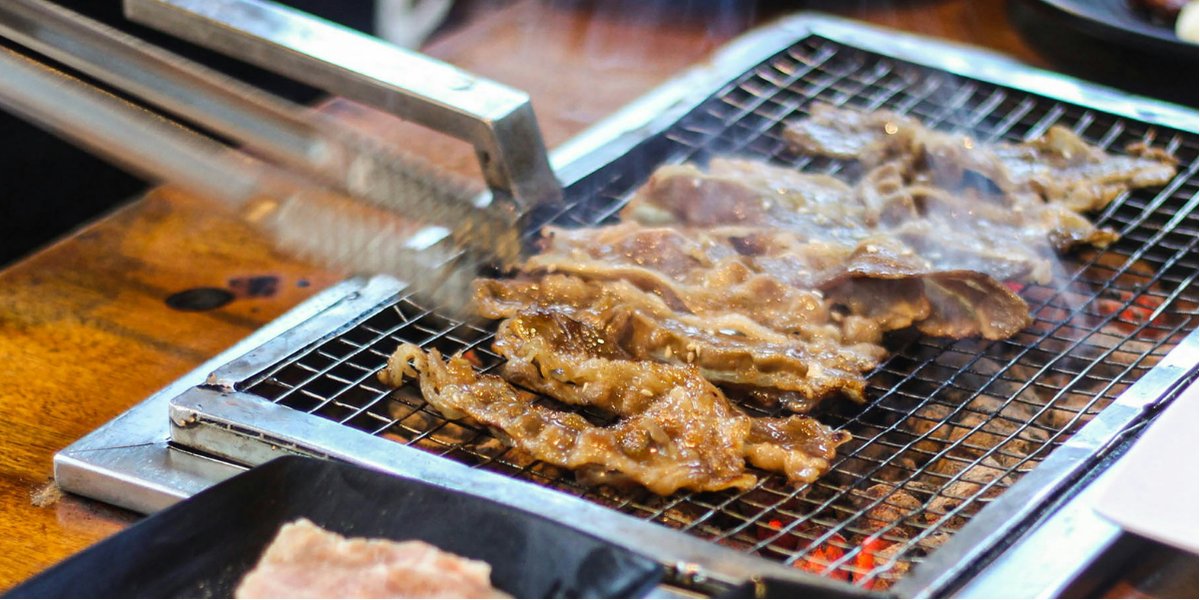 Korean barbecue meat grilling on a tabletop grill